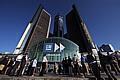 General Motors employees and visitors watch a large video monitor outside the GM World Headquarters.